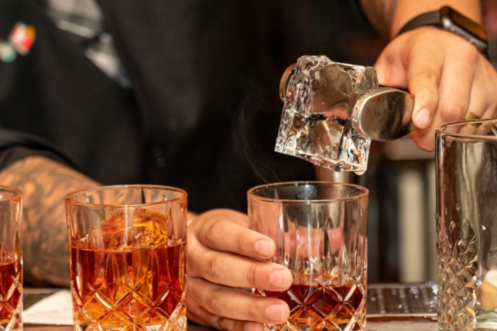 a group of people sitting at a table with a glass of wine