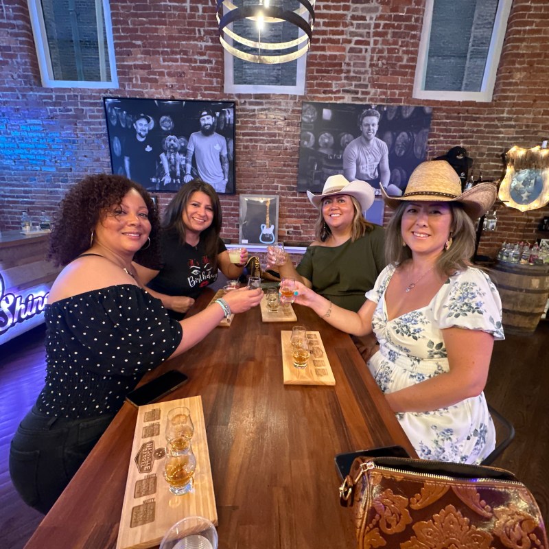 a person sitting at a table in front of a building