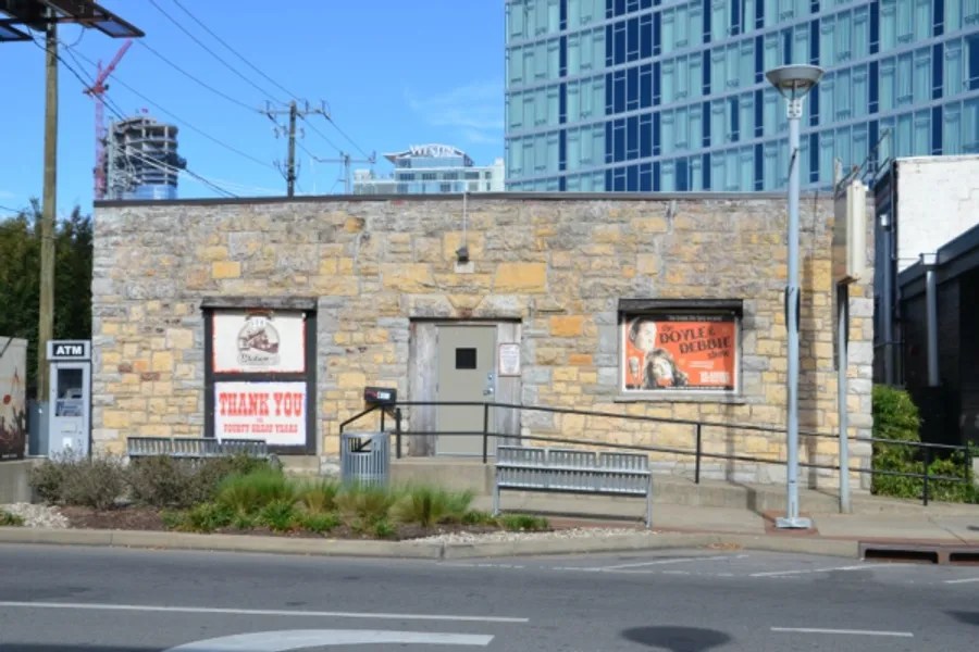 a building that has a sign on the side of a road