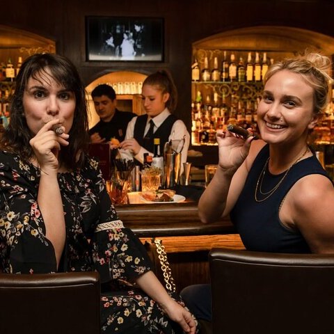 GIRLS AT A SPEAKEASY BAR IN NASHVILLE CIGARS WHIKSEY BOURBON OLD FASHIONED