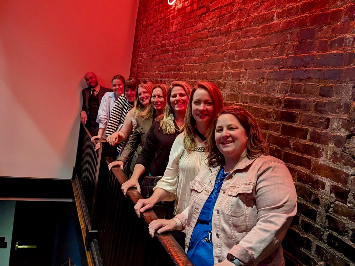 a person standing in front of a brick building