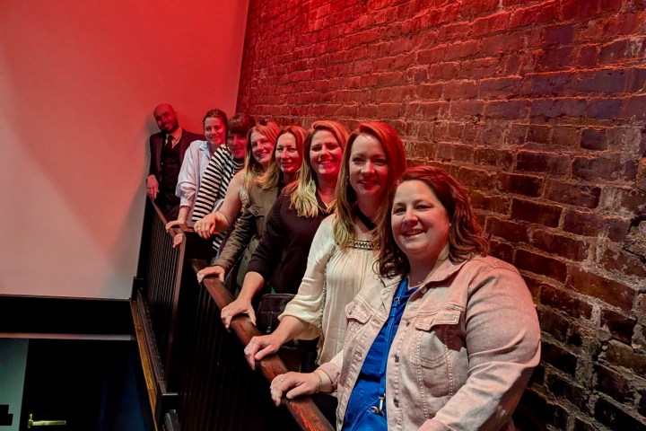 a person standing in front of a brick building