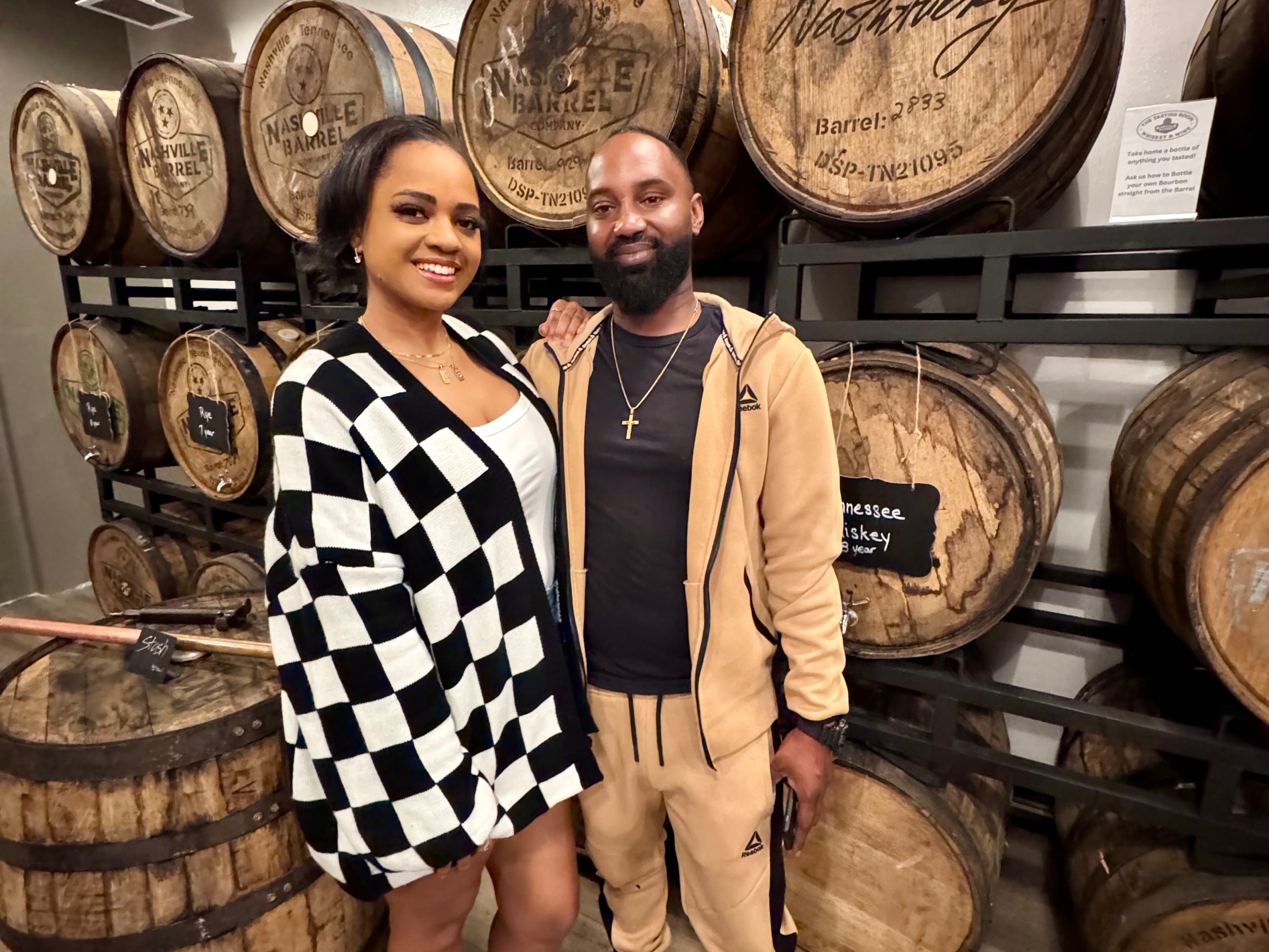 a group of people standing in front of a barrel