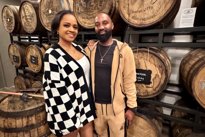 a group of people standing in front of a barrel