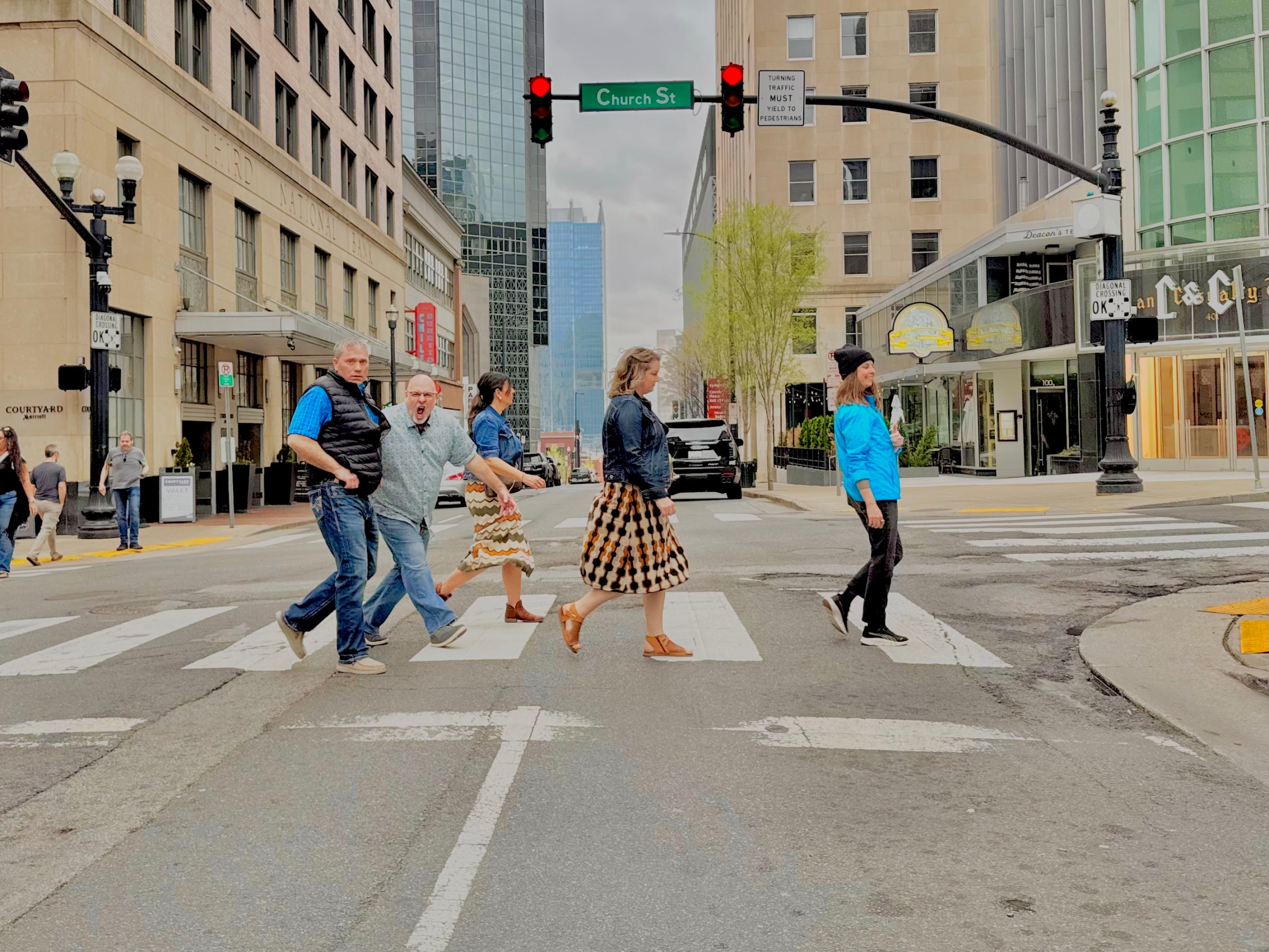 a group of people walking on a city street
