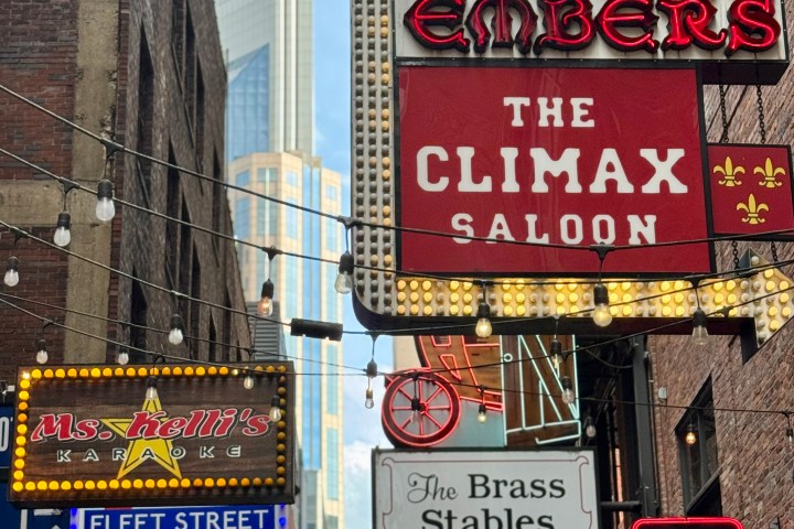 a sign hanging off the side of a building