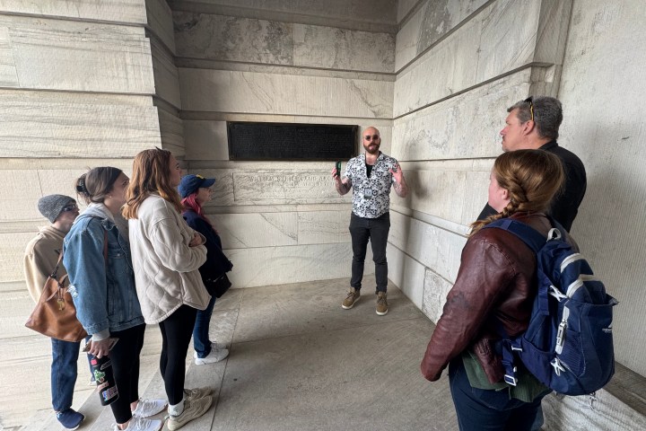 a group of people walking on a sidewalk