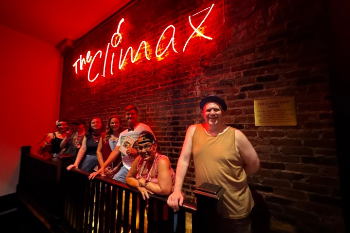 a man standing on a stage in front of a building