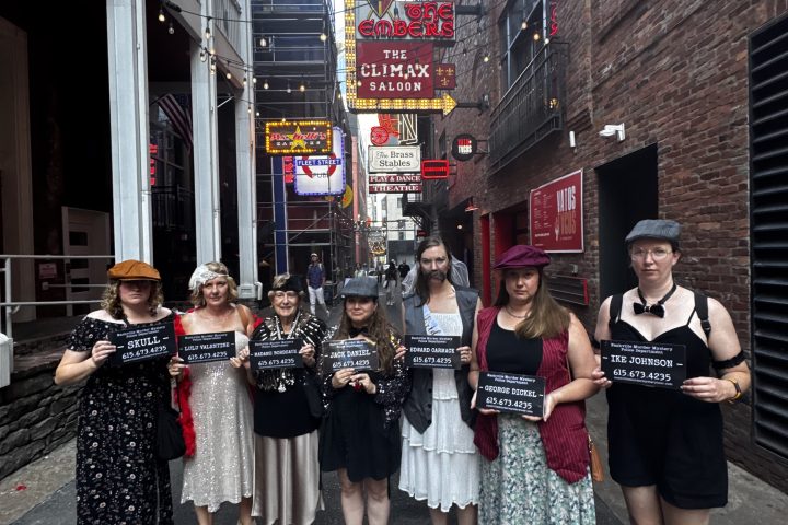 a group of people standing on a sidewalk