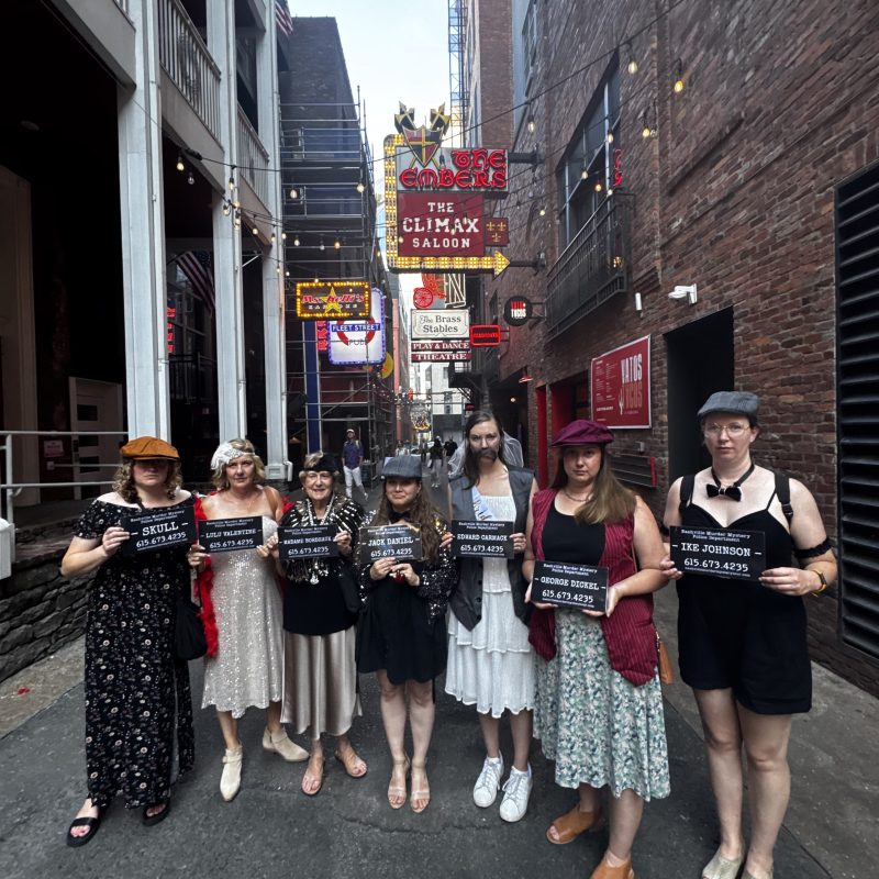 a group of people standing on a sidewalk