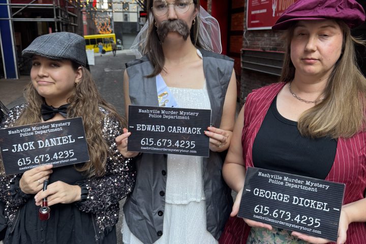 a group of murder mystery tour people posing in printer's alley nashville