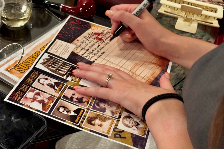 a person sitting at a table with wine glasses